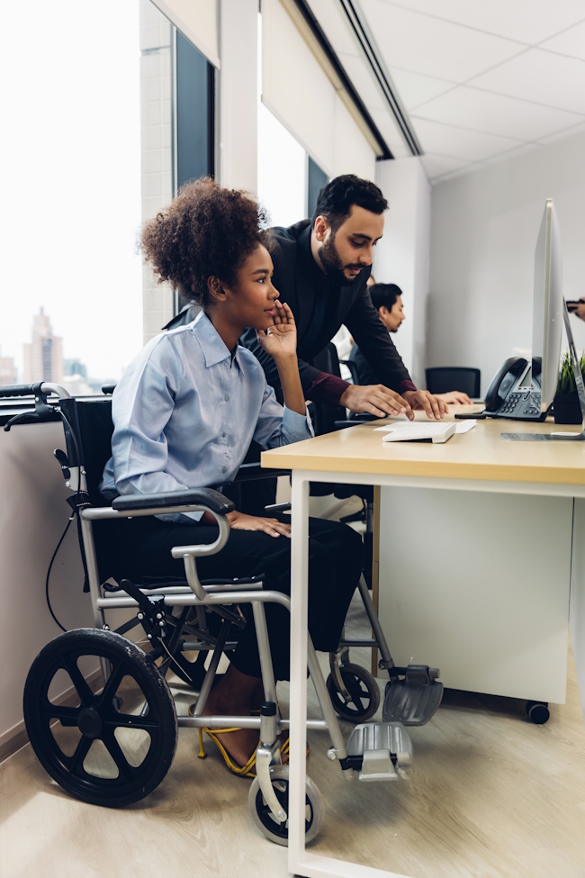 An inclusive workplace with wheel chair accessible desks.