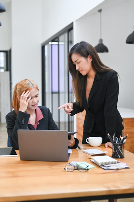 Two women discussing gender issues in their workplace. 