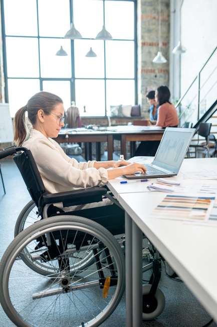 A woman in a wheelchair writing a diversity training program.